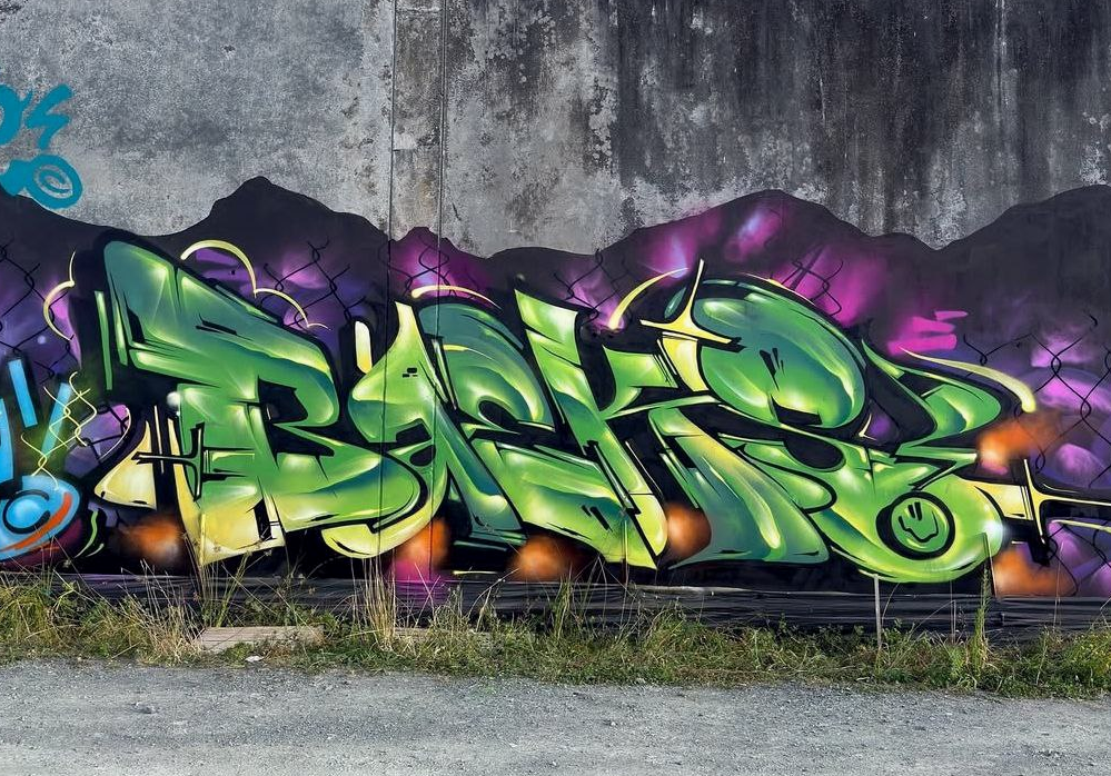 Green graffiti mural on a concrete wall